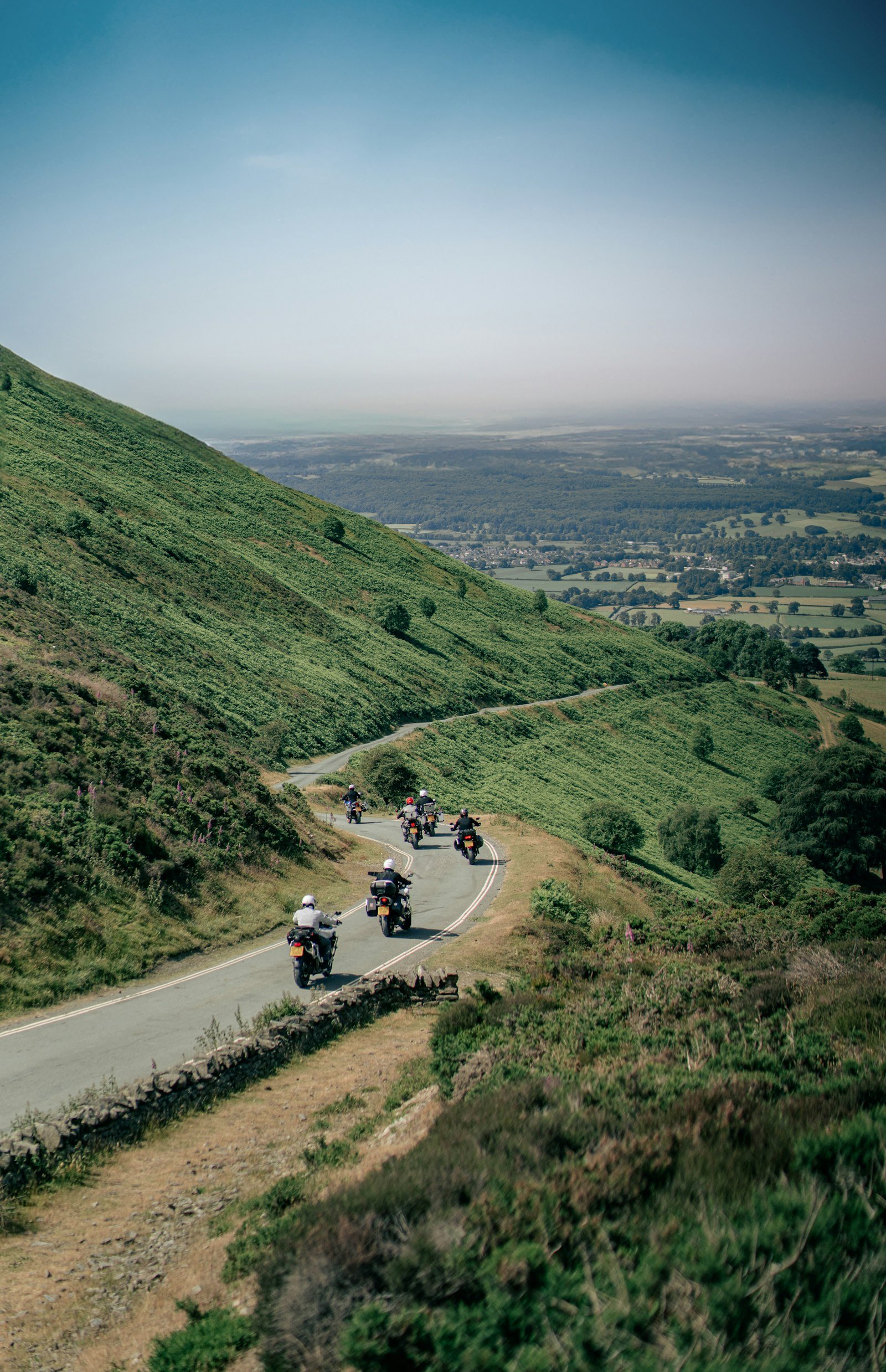 Group of motorcycles riding together on a scenic road